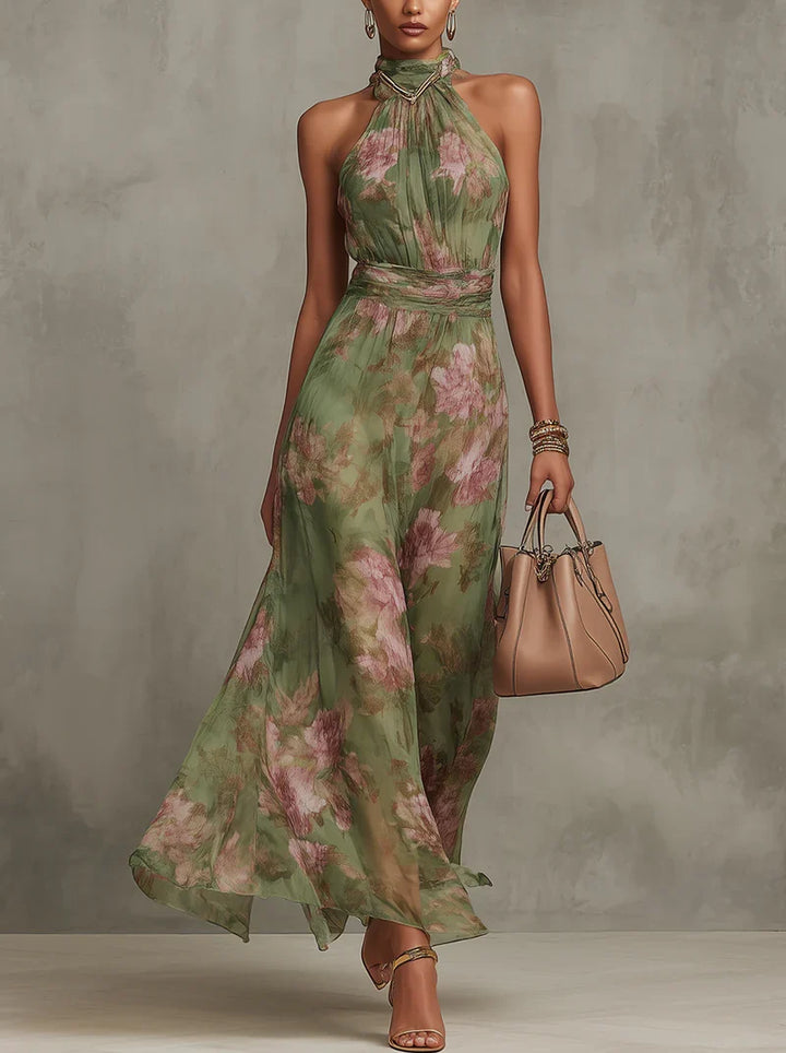 Halter neck floral maxi dress in green botanical print with adjustable neck ties and flowing skirt