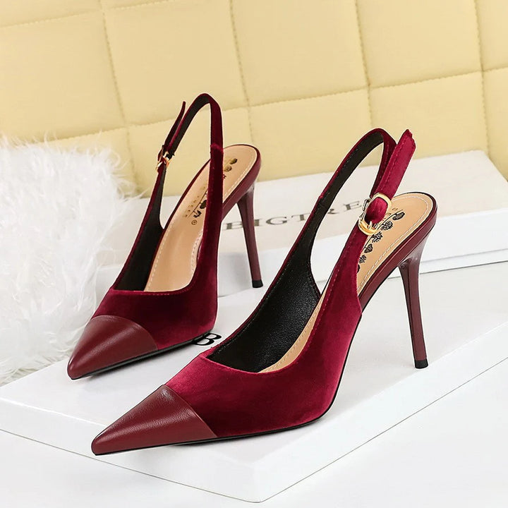 Close-up of pointed toe heels showing contrast cap toe detail and structured upper