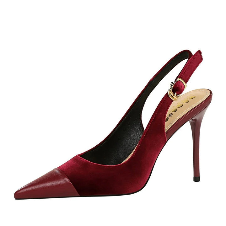 Pair of green slingback heels with adjustable ankle strap on white surface
