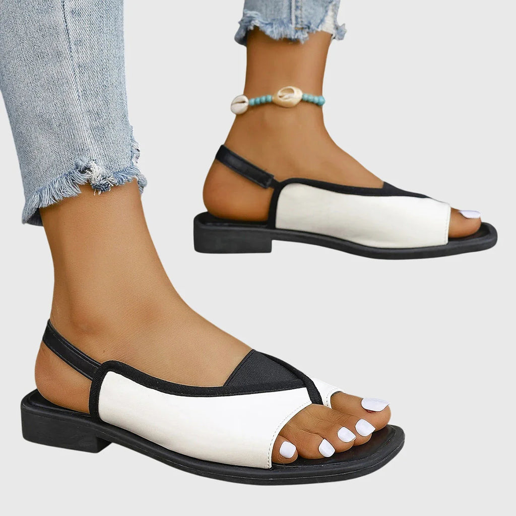 Detail of women's slingback sandals showing contrast stitching and elasticated slingback strap with flat footbed