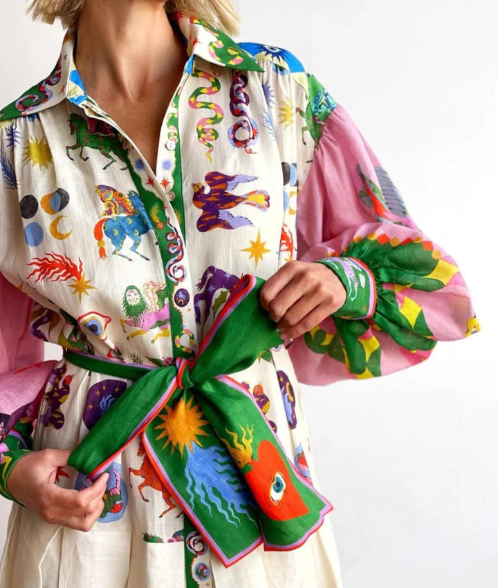 Close-up of printed maxi shirt dress showing button-down front and statement balloon sleeve detail