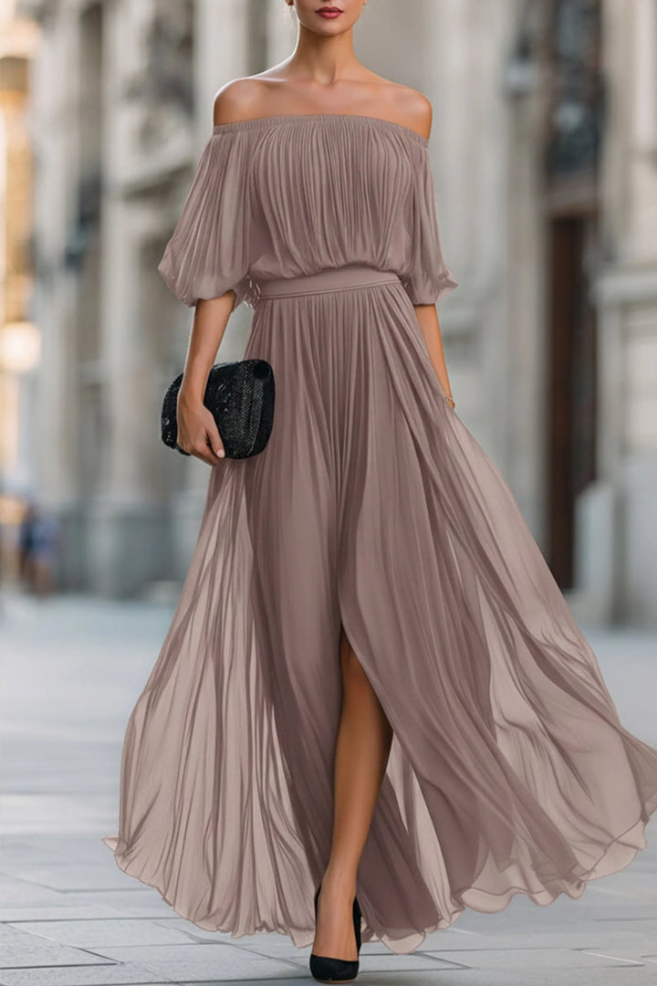 Pleated black maxi dress with bardot neckline styled for formal evening event