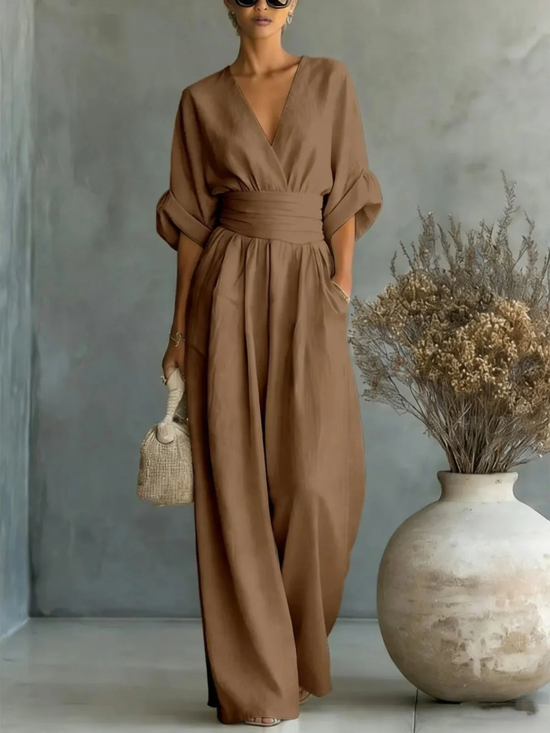 Wide-leg linen jumpsuit styled with sandals for casual spring summer wear