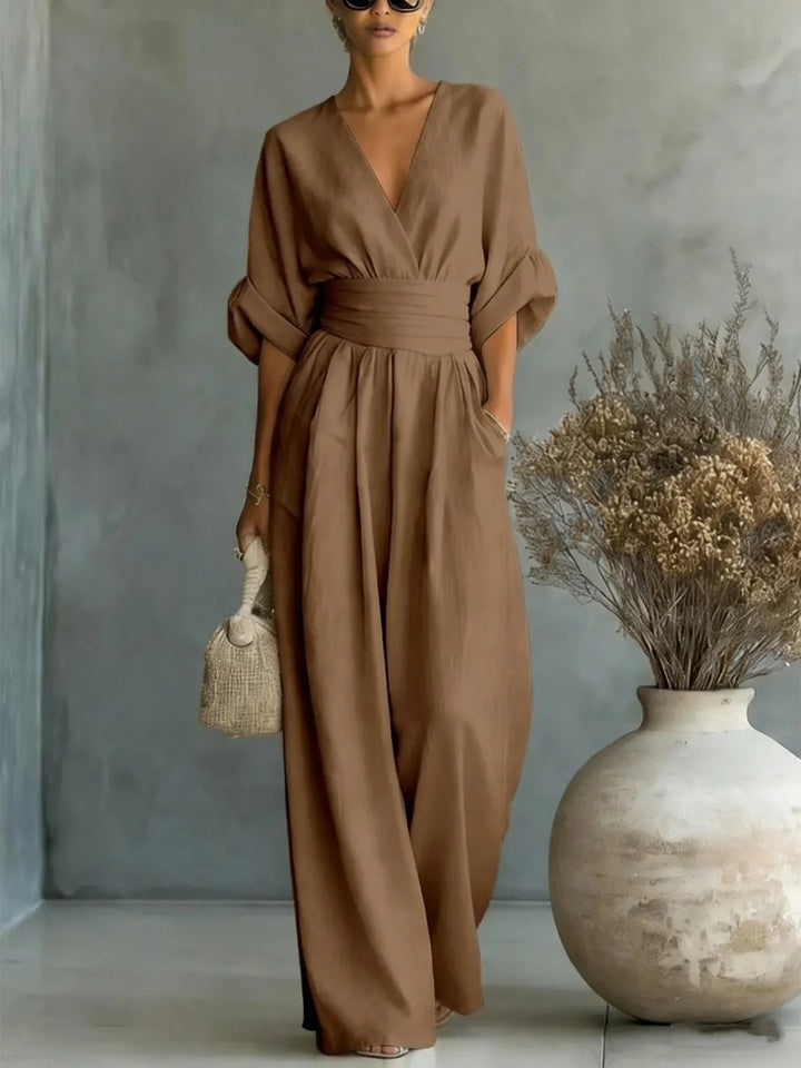 Wide-leg linen jumpsuit styled with sandals for casual spring summer wear