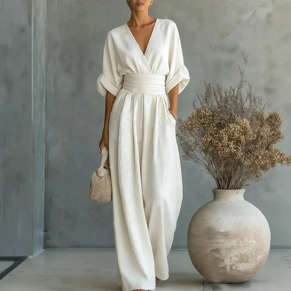 Side angle of women's linen jumpsuit with 3/4 batwing sleeves and side pockets