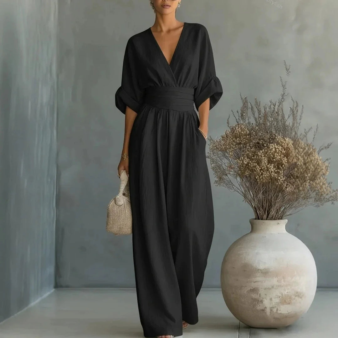 Full-length view of olive green wide-leg jumpsuit with flowing leg cut