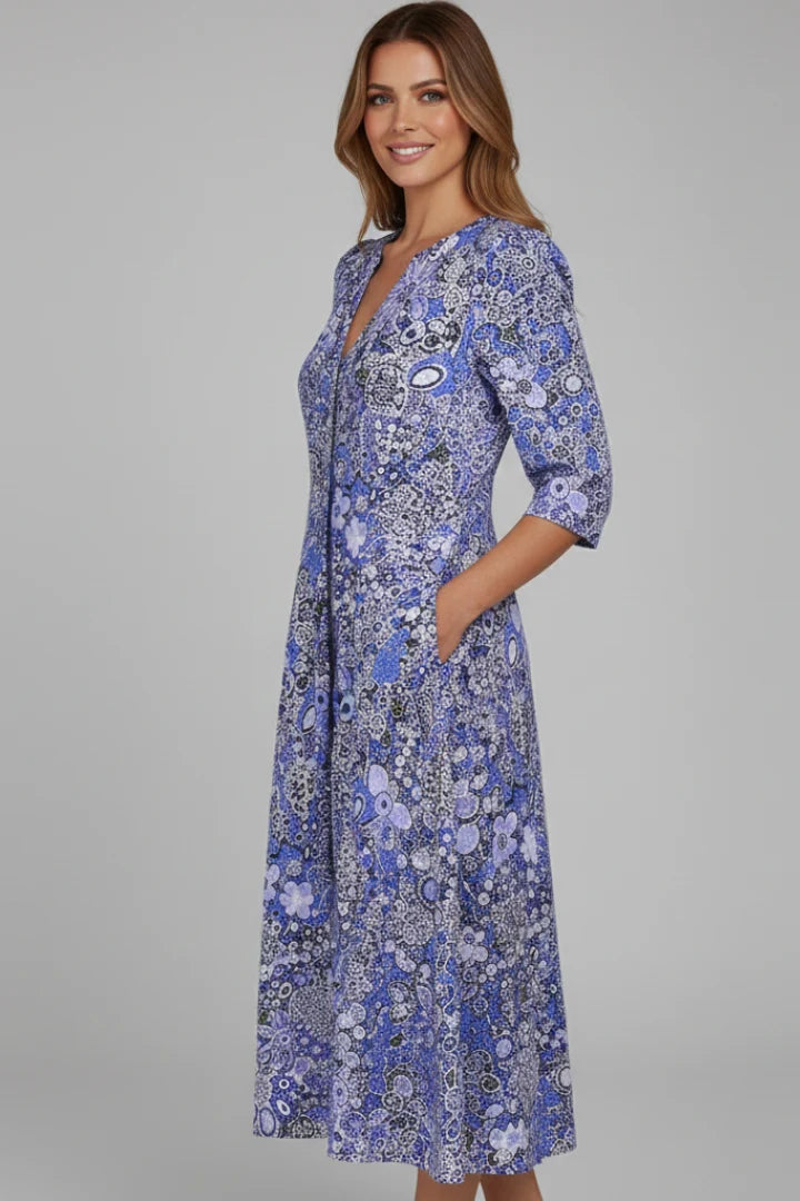 Flared midi dress featuring V-neck and printed surface with comfortable relaxed fit