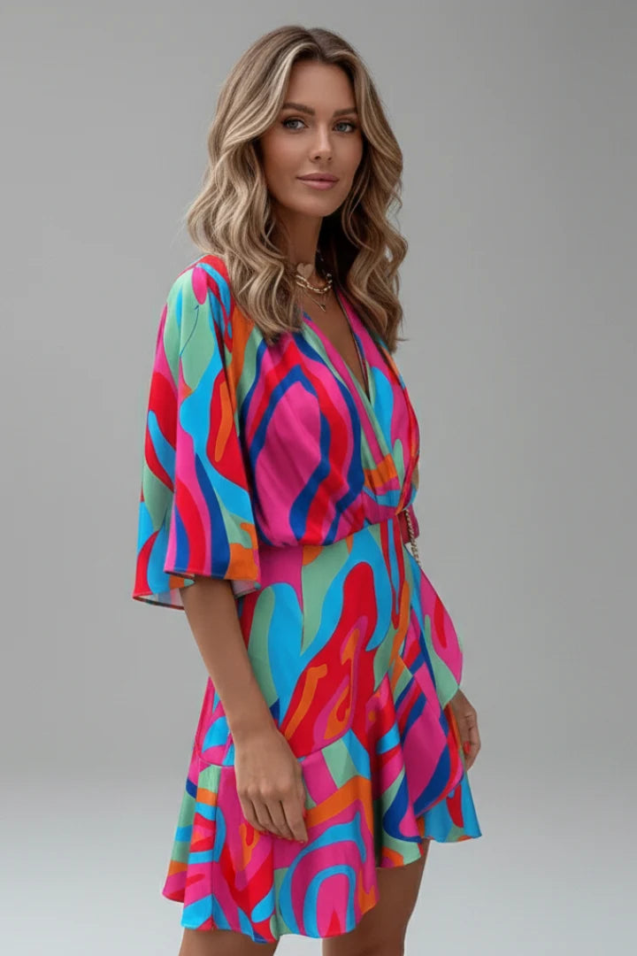 Flowing batwing sleeve dress with V-neck and tie waist in abstract printed fabric
