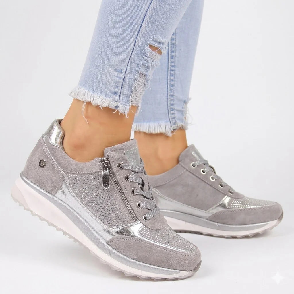 Close-up of grey Orthopedic Zip Sneakers For Women with shimmer mesh panels and side zipper detail worn with light blue jeans