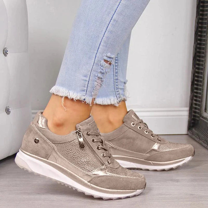 Front angle of grey orthopedic sneakers with lace-up closure and breathable mesh detailing for everyday comfort