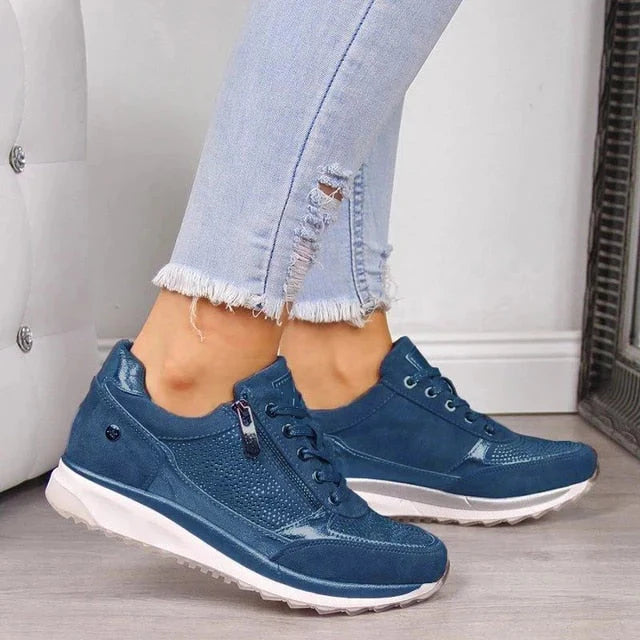 Detail shot of side zipper closure on women's orthopedic sneakers with elevated lightweight sole
