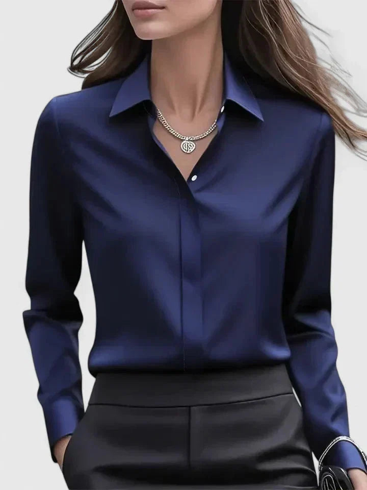 Women's tailored button-down shirt in navy blue with structured pointed collar and long sleeves