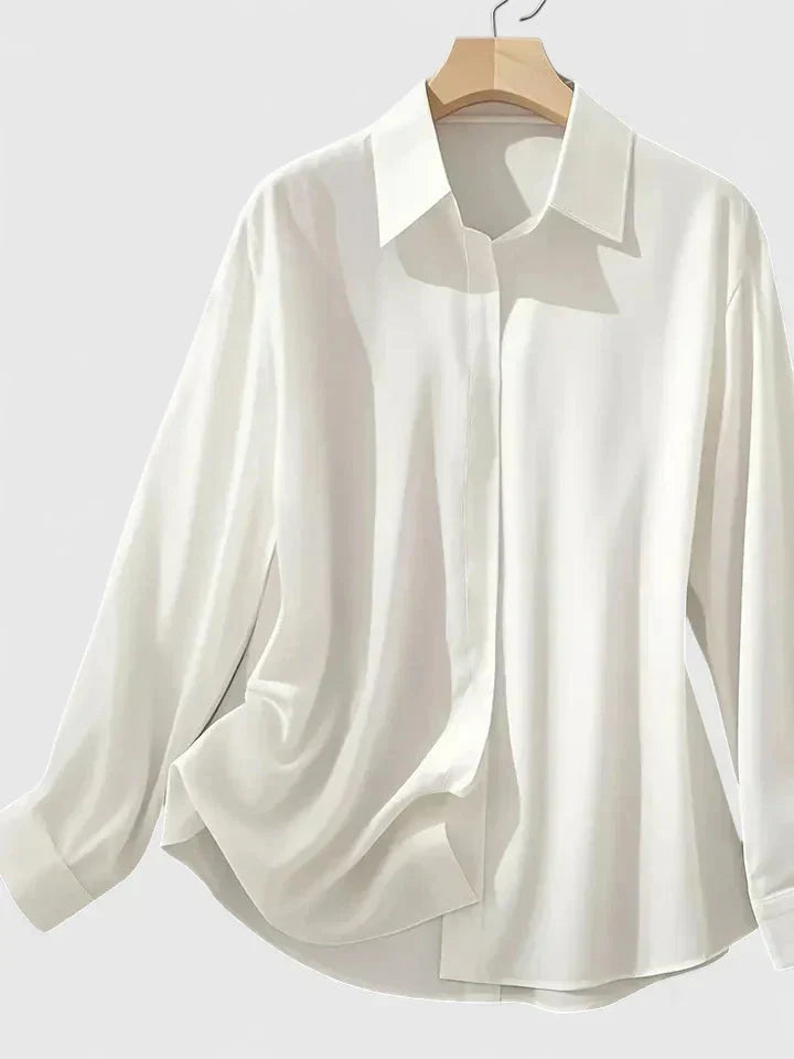 Close-up of women's navy button-down shirt showing smooth fabric and button-front closure detail