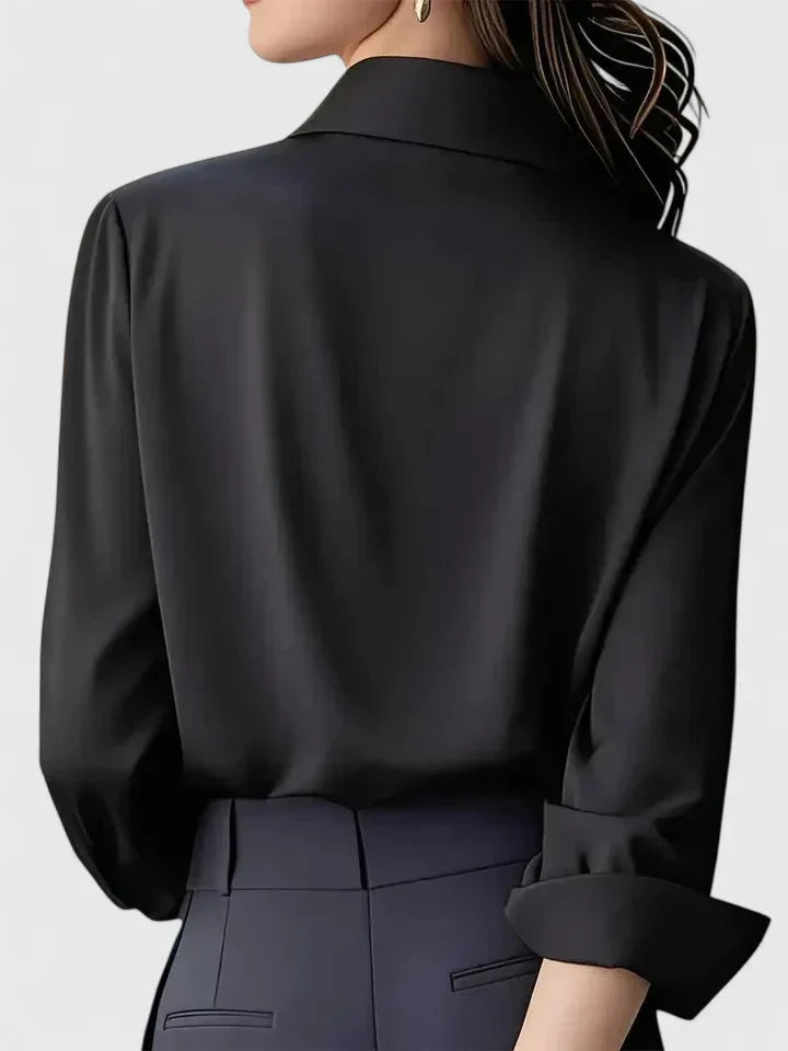 Women's structured collar shirt in navy paired with black trousers for professional styling