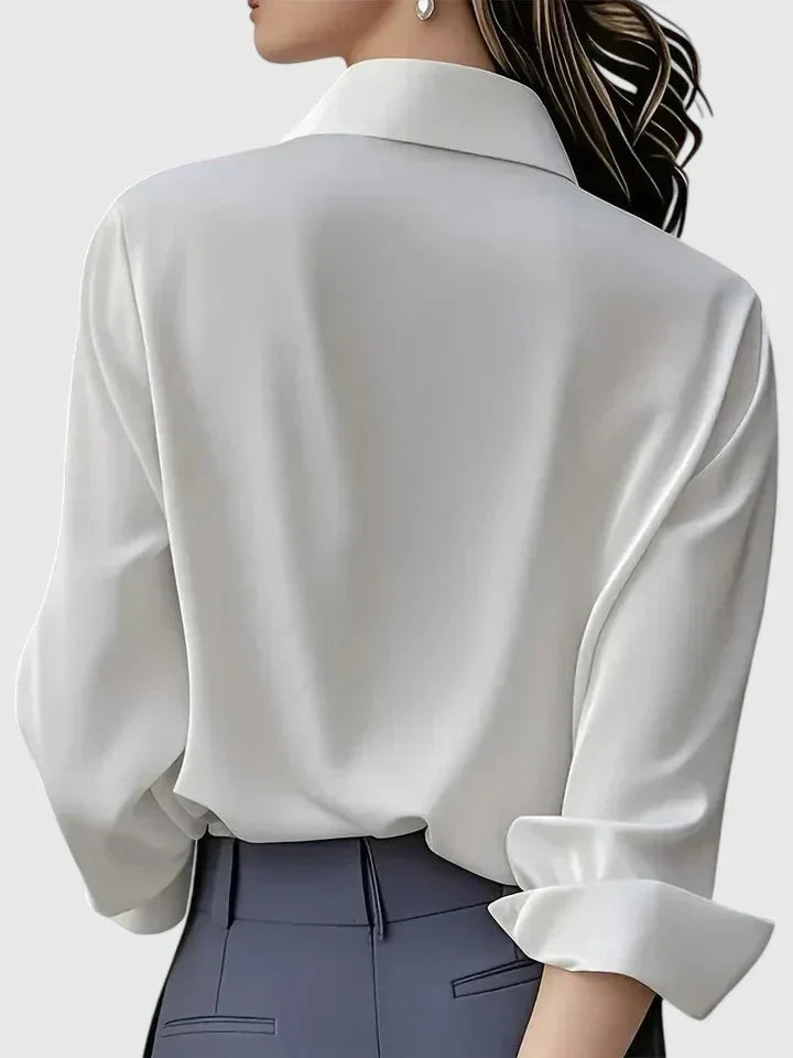 Women's tailored button-down shirt tucked into high-waisted trousers for office look