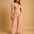Peach puff sleeve wide leg jumpsuit with deep V-neckline and tailored waist detail for formal occasions