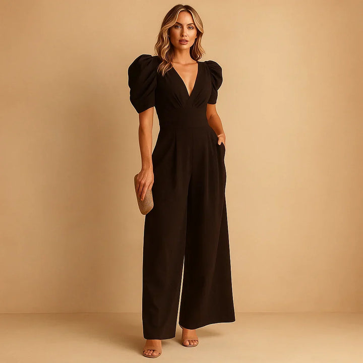 Side view of wide leg jumpsuit showing puff sleeve detail and pleated leg silhouette