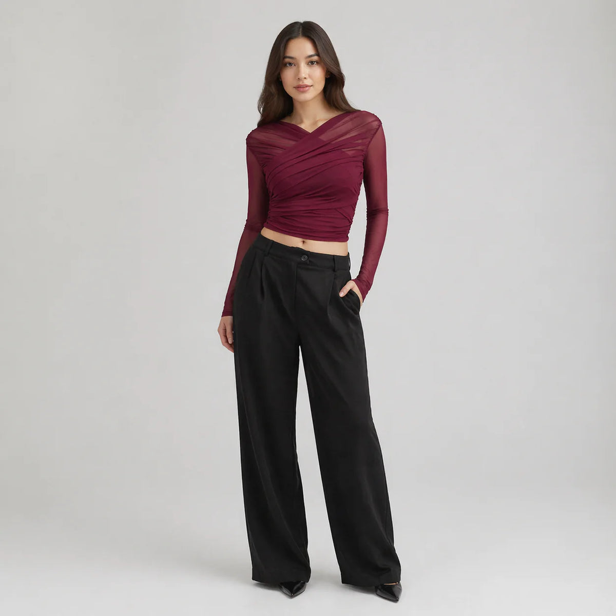 Charlotte ruched wrap mesh top for women in burgundy with diagonal wrap design and sheer long sleeves styled with black trousers