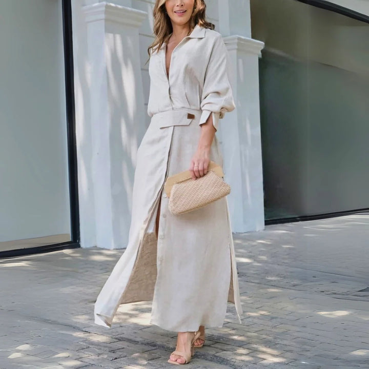 Woman wearing beige elegant maxi dress with V-neck and button-front closure in natural light