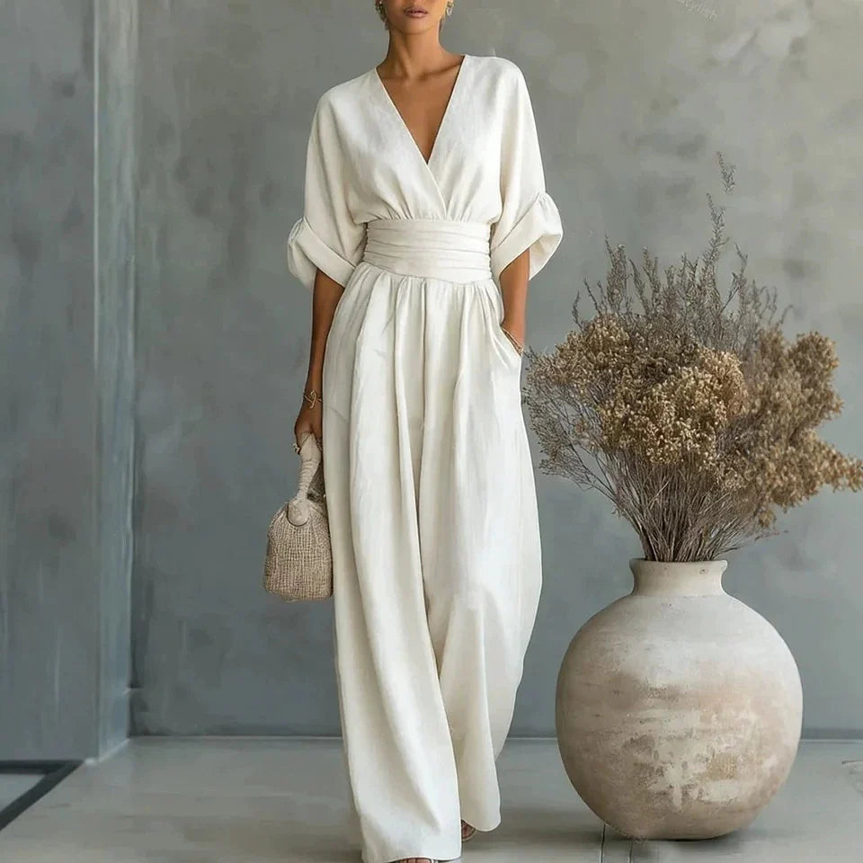 Side angle of women's linen jumpsuit with 3/4 batwing sleeves and flowing wide-leg trousers