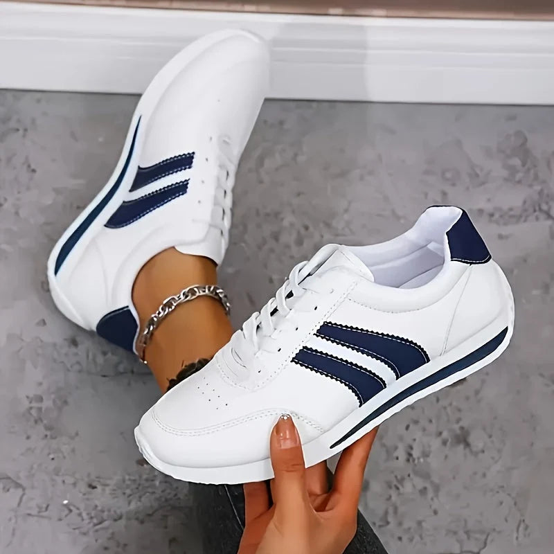 Women's orthopedic trainers in white with navy stripe detailing and cushioned sole for all-day support
