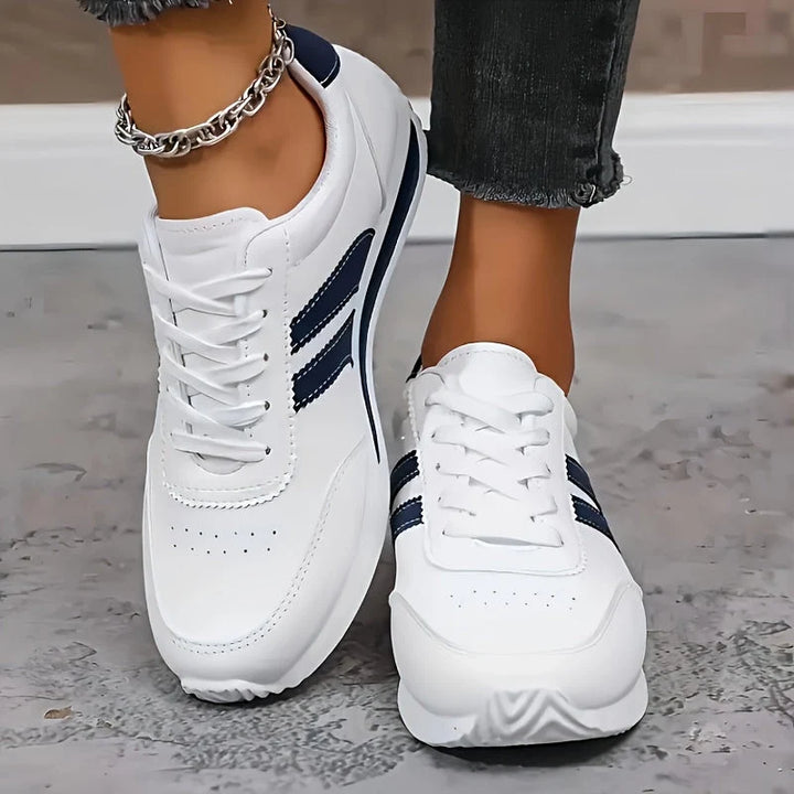 Women's supportive trainers with cushioned insole and lace-up closure in classic white and navy colourway