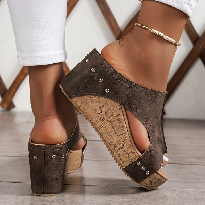 Black wedge sandals with back strap and cork platform heel worn for casual summer style