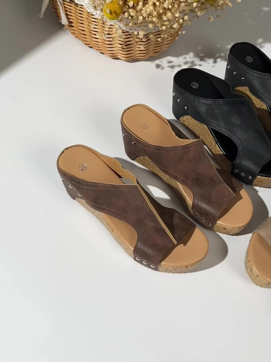 Cork platform wedge sandals in black with open-toe design and slip-on silhouette for easy wear