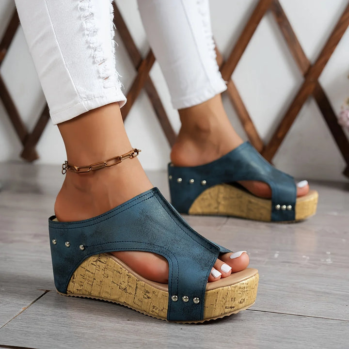 Women's cork platform wedge sandals in black featuring smooth upper and open-toe silhouette