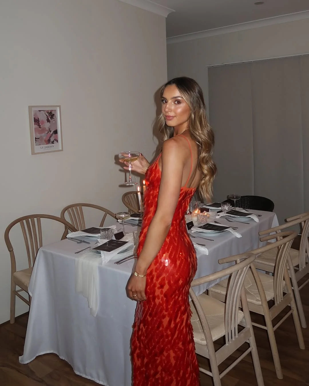 Full-length view of red sequin evening dress with halter neckline and floor-length maxi hem