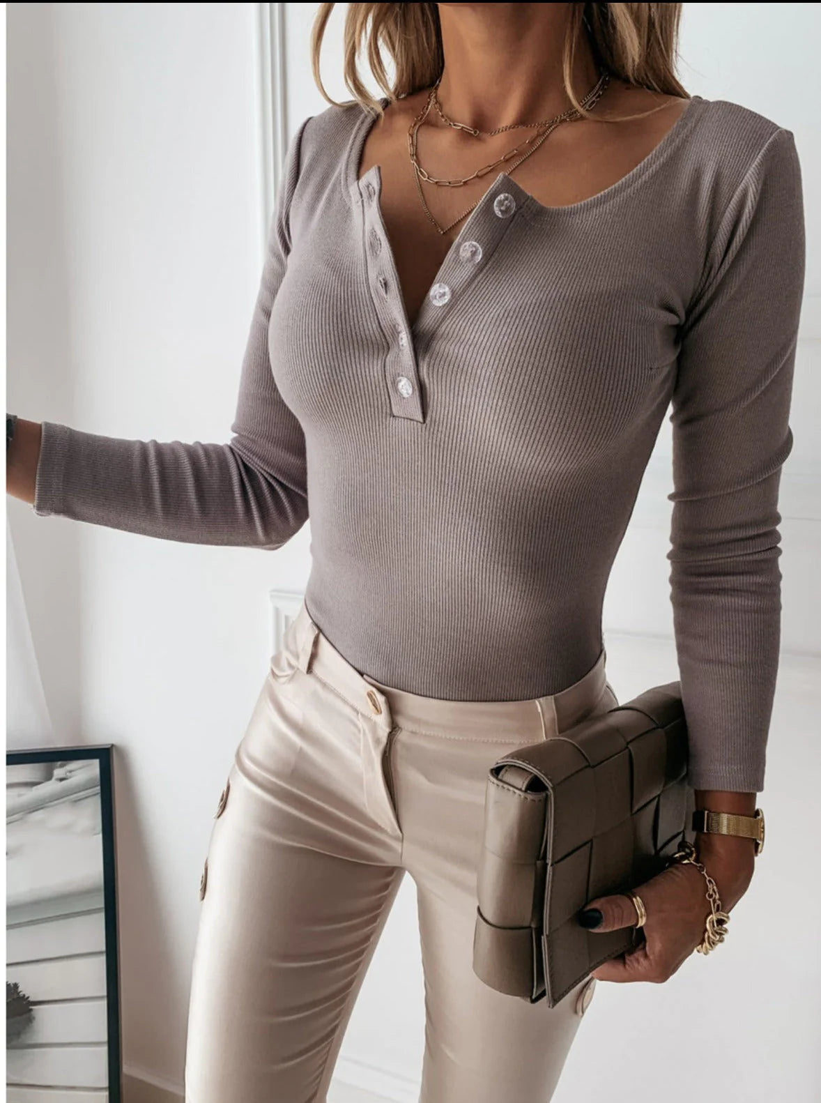 Woman wearing ribbed button long sleeve top for women in neutral beige tone
