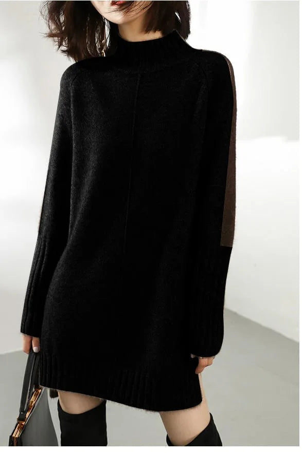 Detail shot of ribbed cuffs and soft knit texture on women's turtle neck jumper dress