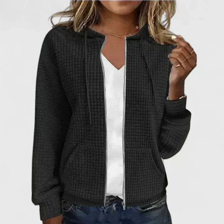 Women's quilted zip front jacket in black with round neckline and textured quilted design