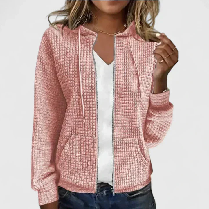 Close-up view of women's quilted zip front jacket showing textured quilted surface and zip closure