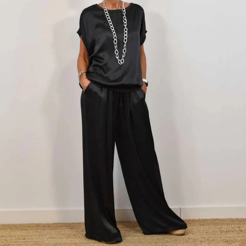 Side view of relaxed fit two-piece set showing wide leg trouser silhouette and loose top drape