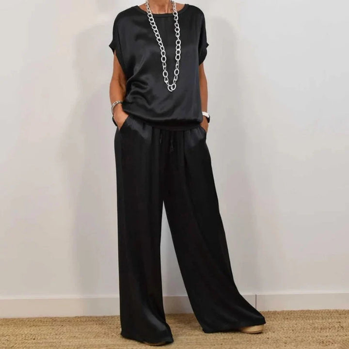 Side view of relaxed fit two-piece set showing wide leg trouser silhouette and loose top drape