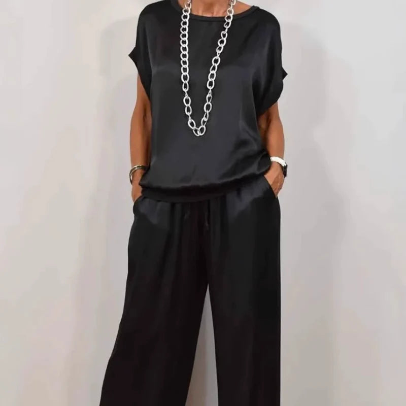 Detail of round neckline and short sleeves on relaxed fit top from two-piece set