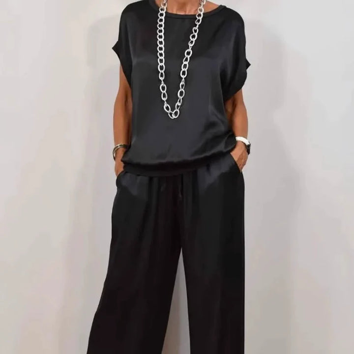 Detail of round neckline and short sleeves on relaxed fit top from two-piece set