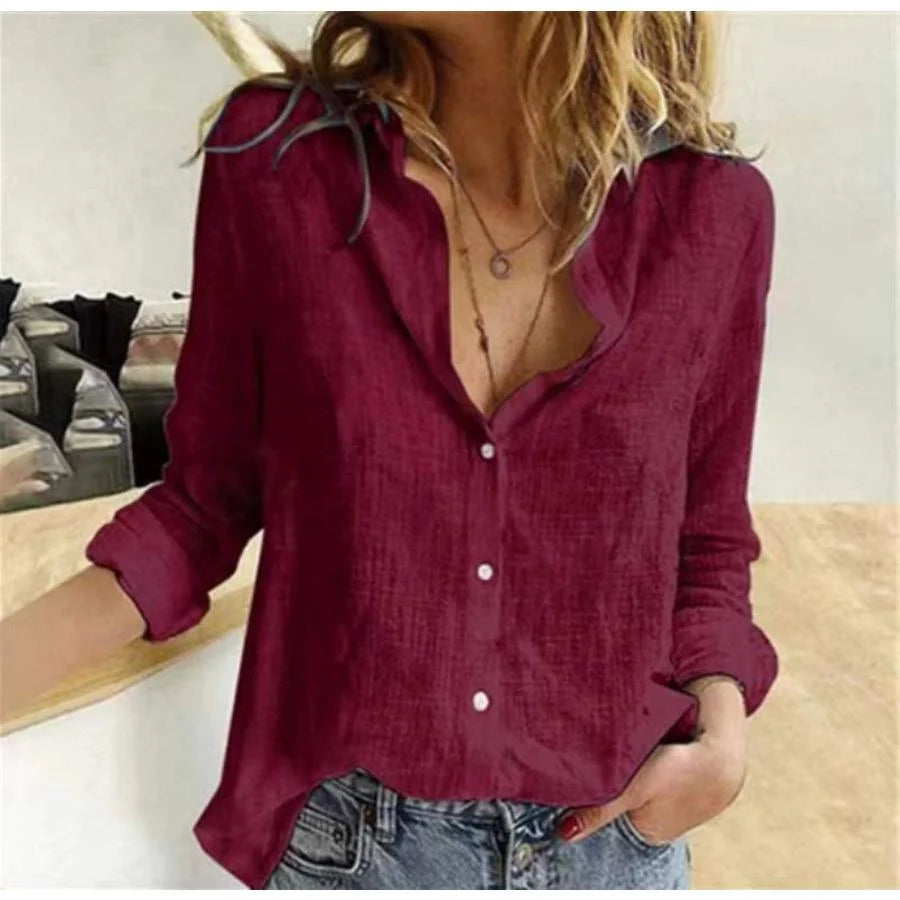 Women's long sleeve shirt in burgundy with V-neckline and button-front closure styled with denim jeans