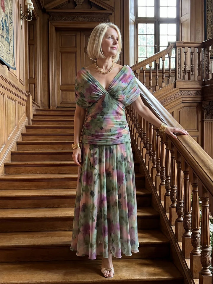 Full-length formal dress showing watercolour print and flowing silhouette