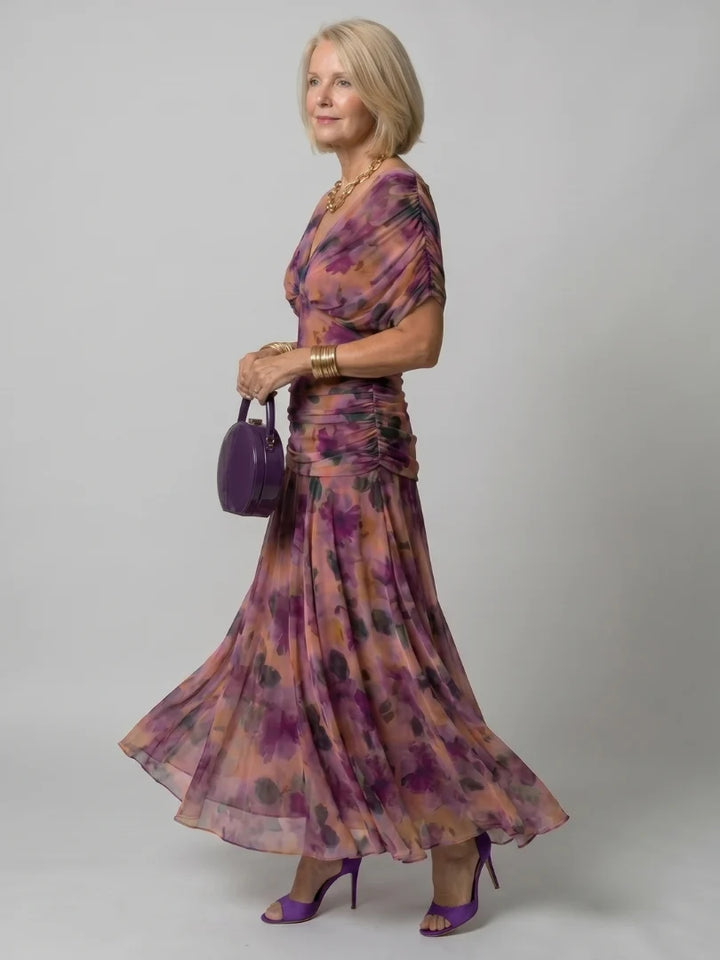 Front view of purple floral maxi dress with draped neckline and flowing skirt