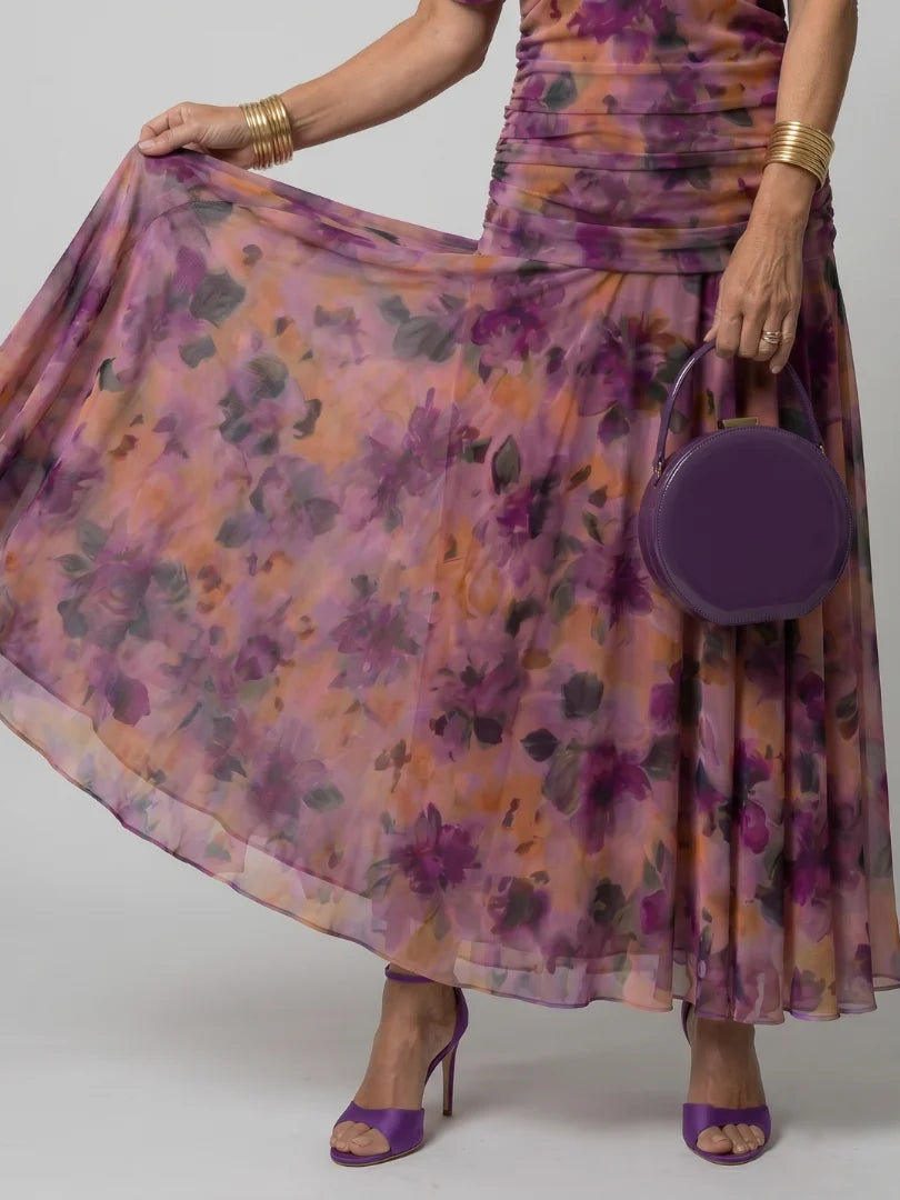 Side angle of off-shoulder dress showing A-line silhouette and sheer overlay fabric