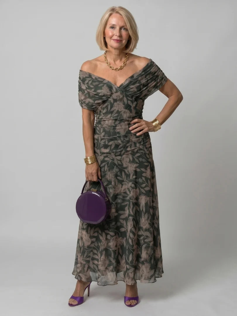 Back view of off-shoulder maxi dress with gathered waist and full-length skirt
