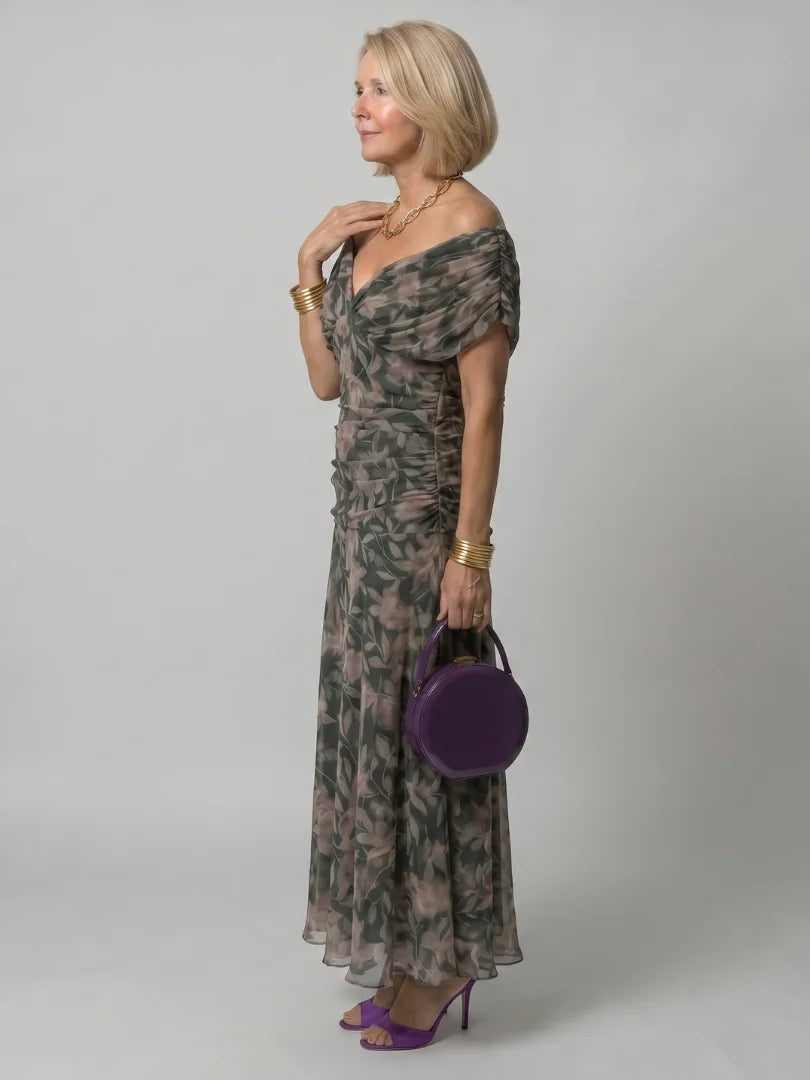 Close-up of draped neckline and purple floral pattern on formal dress