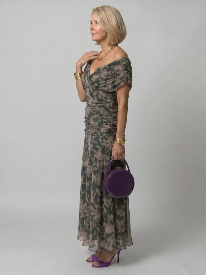 Close-up of draped neckline and purple floral pattern on formal dress