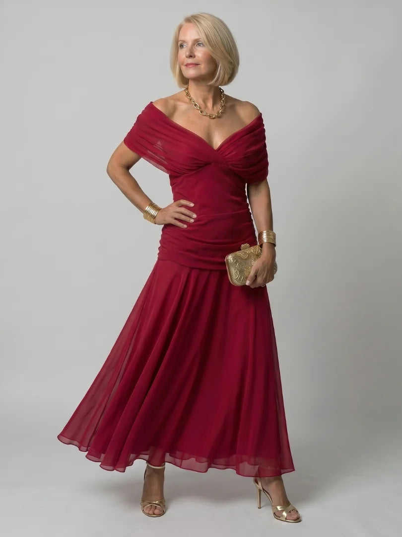 Off-shoulder dress in watercolour print showing movement and drape of fabric