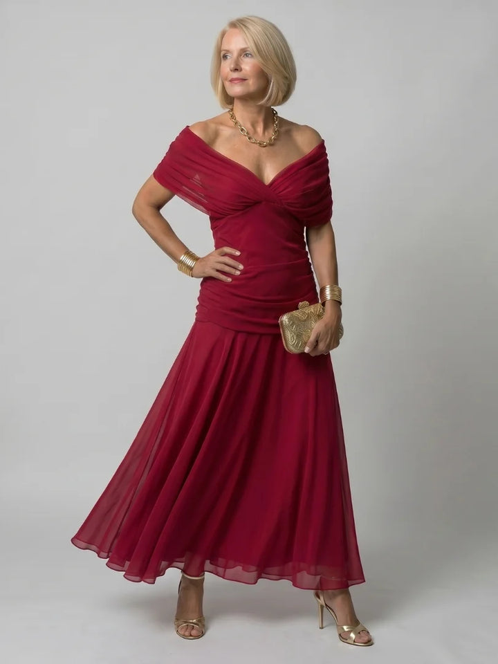 Off-shoulder dress in watercolour print showing movement and drape of fabric