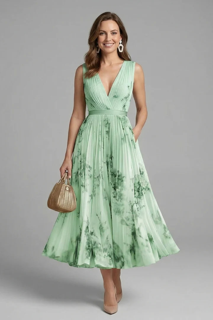 Full silhouette of the Women's Sleeveless Dress with V-Neck and Pleated Skirt in soft pink floral print