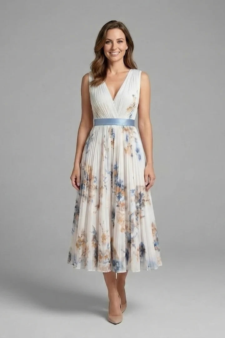 Full-length view of the fitted waist and flared pleated skirt on the sleeveless V-neck dress