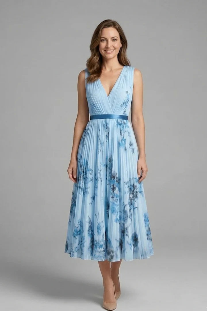 Three-quarter view showing the structured bodice and flowing pleated midi skirt of the sleeveless dress
